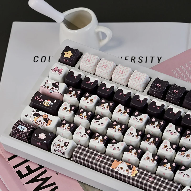 Detail shot of a Cow Cat keycap, showing dye-sublimated legends and smooth finish