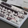 Cow Cat keycaps with backlighting shining through, demonstrating translucent properties