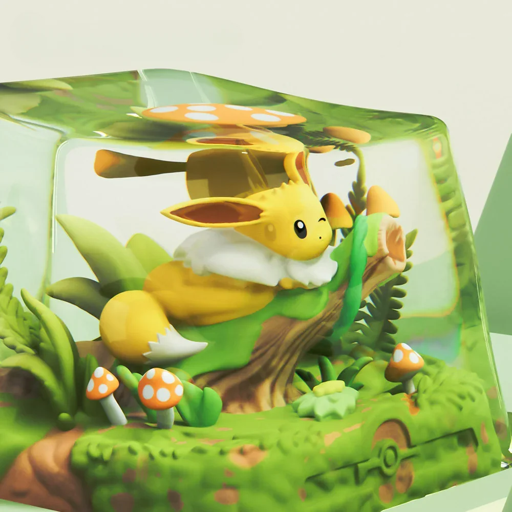 Collection of Eevee artisan keycaps with varying light effects on a desk