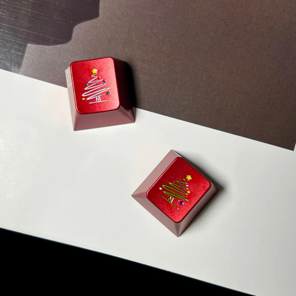 Close-up of the intricate metallic Christmas tree and snowflake design on the keycap