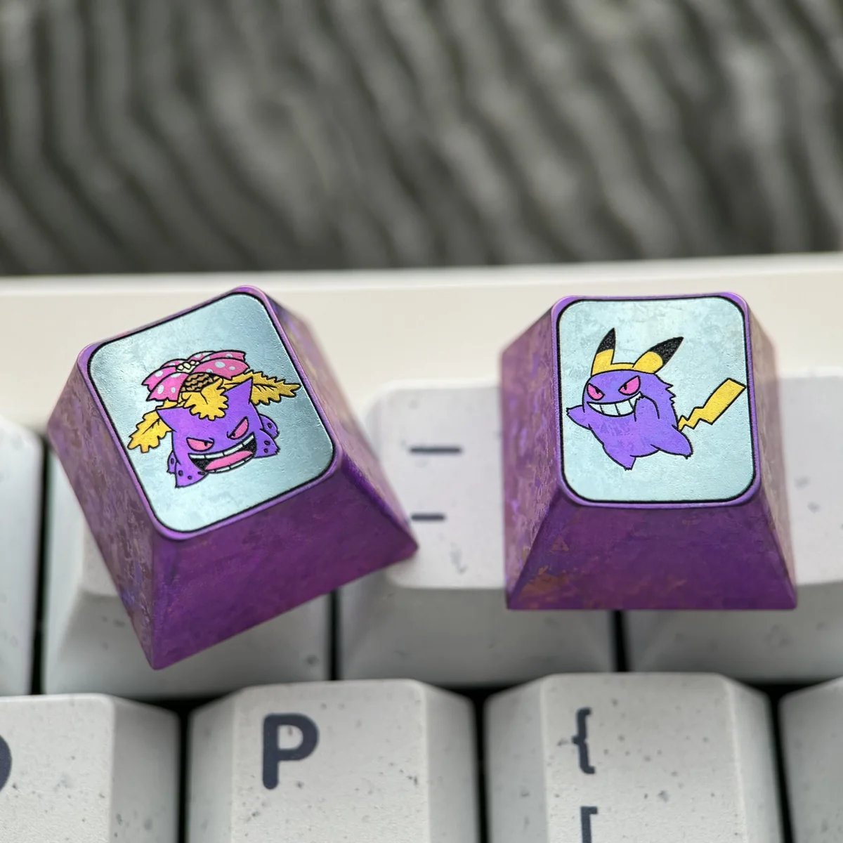 Close-up of the Gengar Titanium Keycap, highlighting the precision CNC machining and smooth finish.