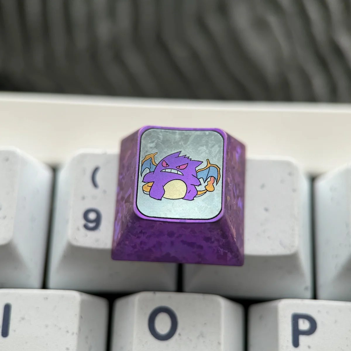 Overhead view of the titanium Gengar keycap, emphasizing its 1U size and the iconic character's form.
