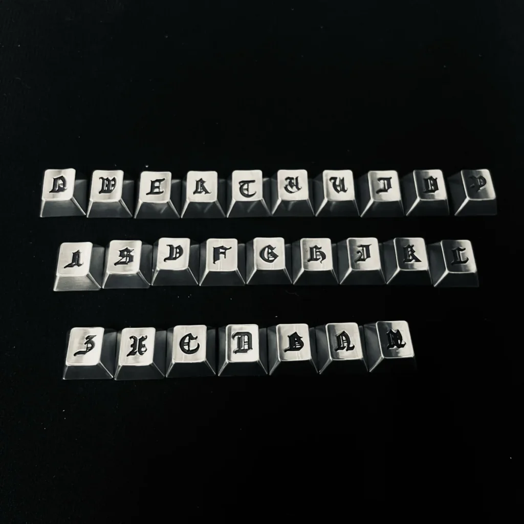 Close-up of a handcrafted Gothic alphabet keycap showing intricate details and dark finish.