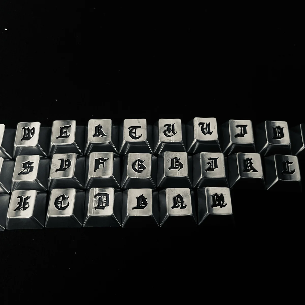 The Gothic Alphabet Keycap Set presented in its premium packaging.