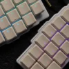Grey low-profile Choc V1 keycaps with vibrant backlighting effect