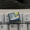 Close-up of handcrafted titanium keycap with black cat silhouette and starry background
