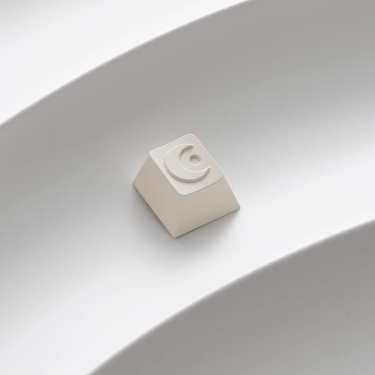 A single Moon Series ESC keycap detached, showing MX stem compatibility