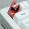 Side view of Patrick Star resin keycap on a switch stem