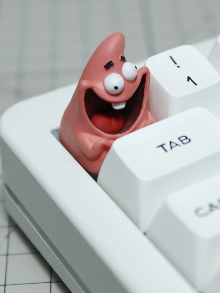 Side view of Patrick Star resin keycap on a switch stem
