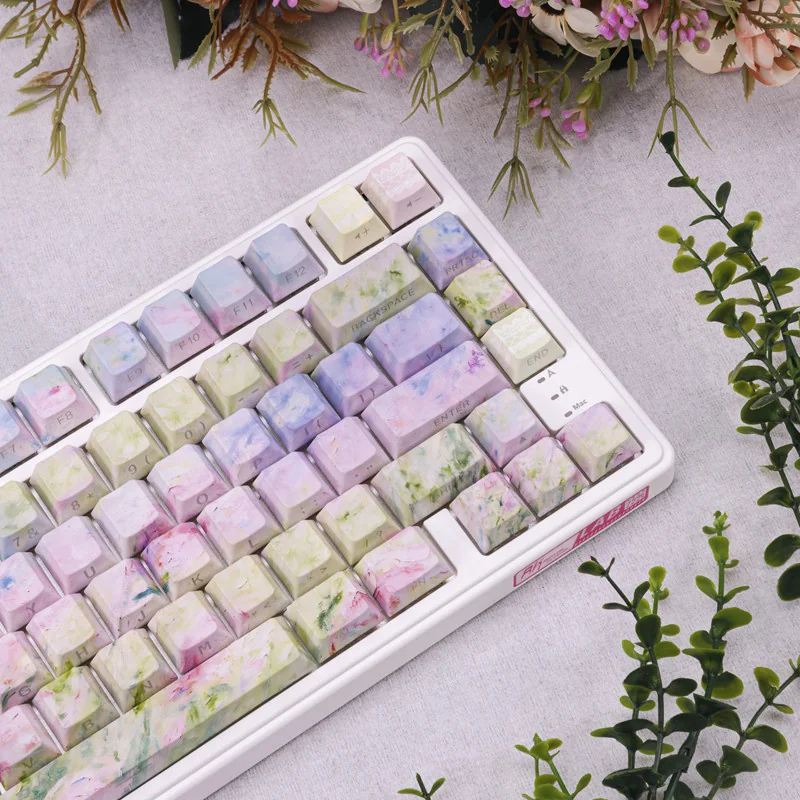Detail shot of PBT Dye-Sub keycaps featuring serene floral motifs and spring landscapes