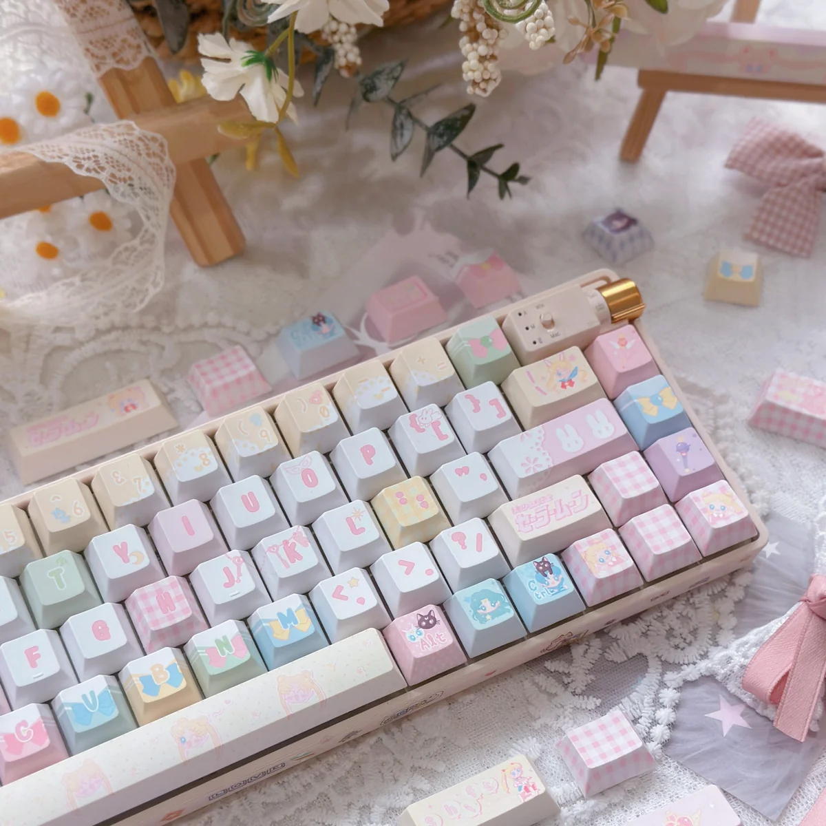 Individual keycaps from the Sailor Moon set, showing different characters like Sailor Mercury, Mars, Jupiter, and Venus.