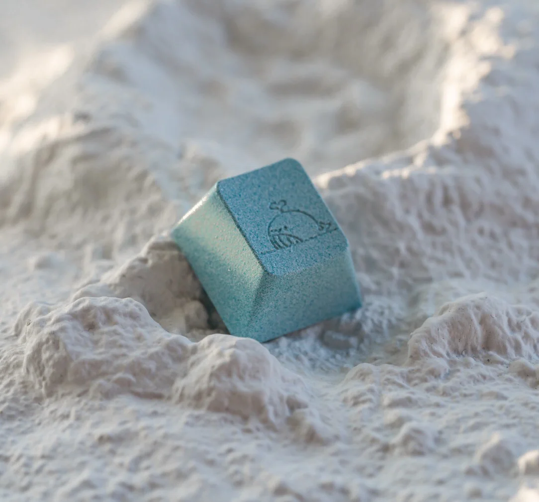 Close-up of Sea Salt Whale aluminum keycap on a mechanical keyboard
