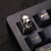 A brass skull keycap mounted on an ESC key position, integrating with a dark themed keyboard.