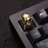 Collection of skull keycaps showcasing different angles and the raw metallic texture.