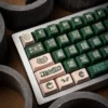 Detail shot of an OEM profile keycap from the Ancient Bronze set, showing its sculpted shape and side-printed legend.