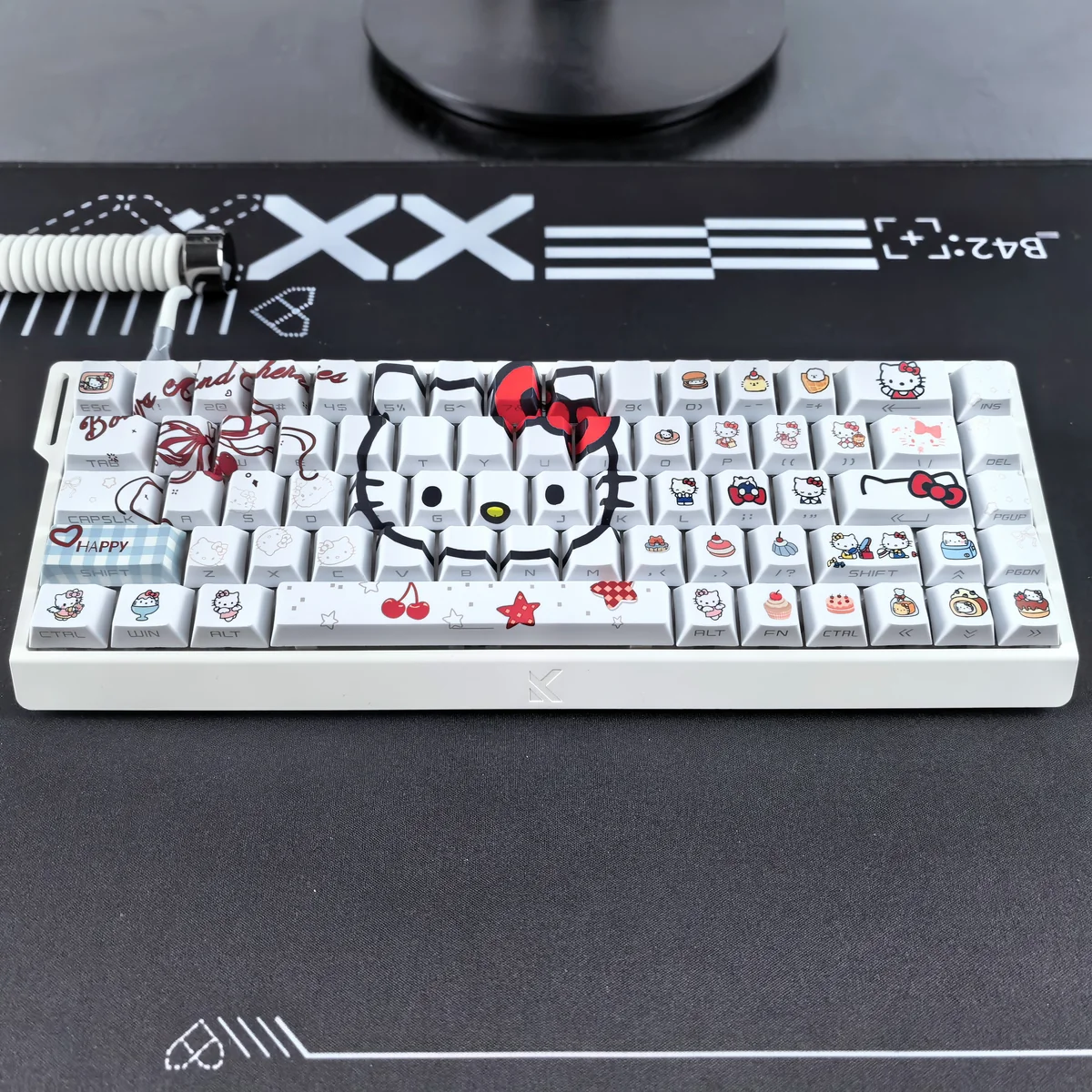 Hello Kitty keycap set illuminated by RGB backlighting, showing the glow-through effect.