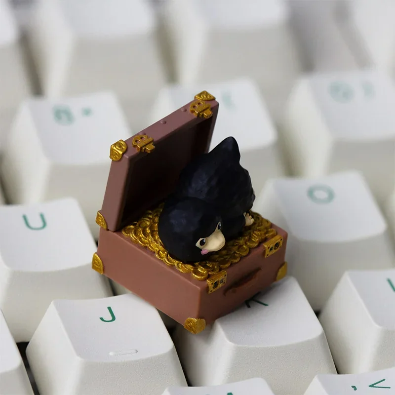 Close-up of the Niffler artisan keycap, showing its unique features and dark tones