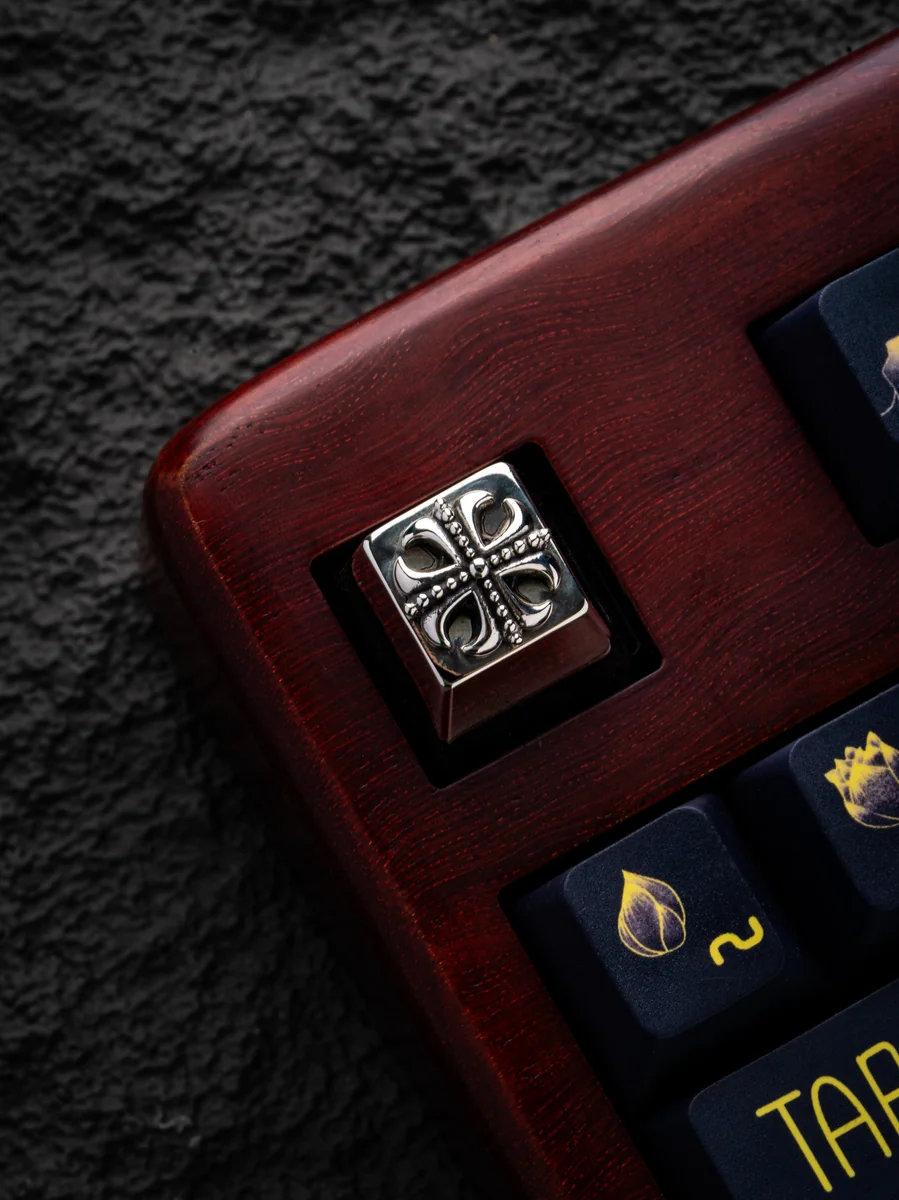 Detail of engraved Cross artwork on a custom brass keycap