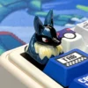 Collection of artisan keycaps with Lucario keycap as a centerpiece on a custom keyboard.