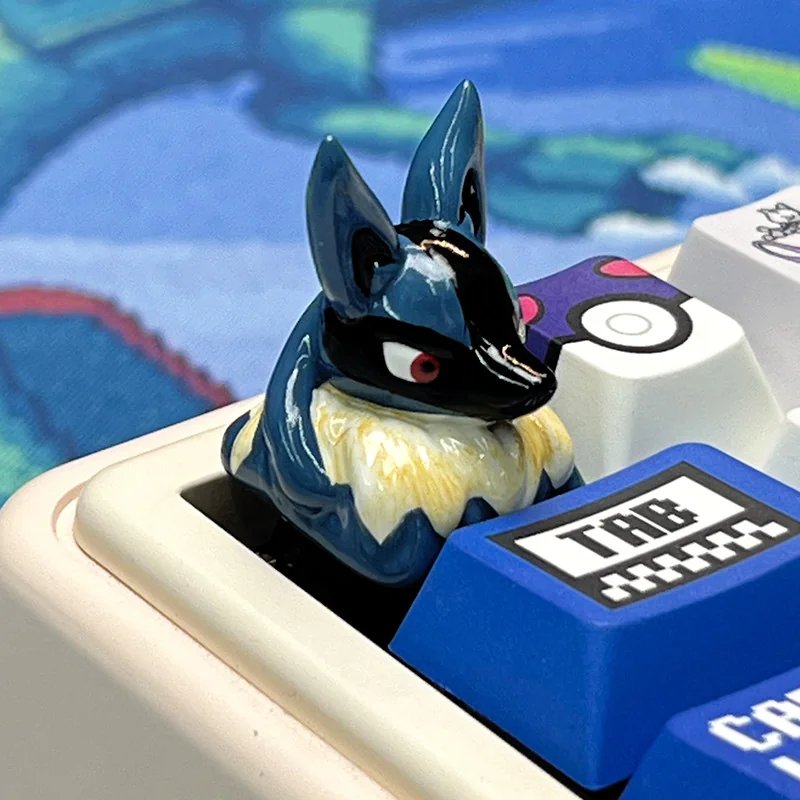 Collection of artisan keycaps with Lucario keycap as a centerpiece on a custom keyboard.