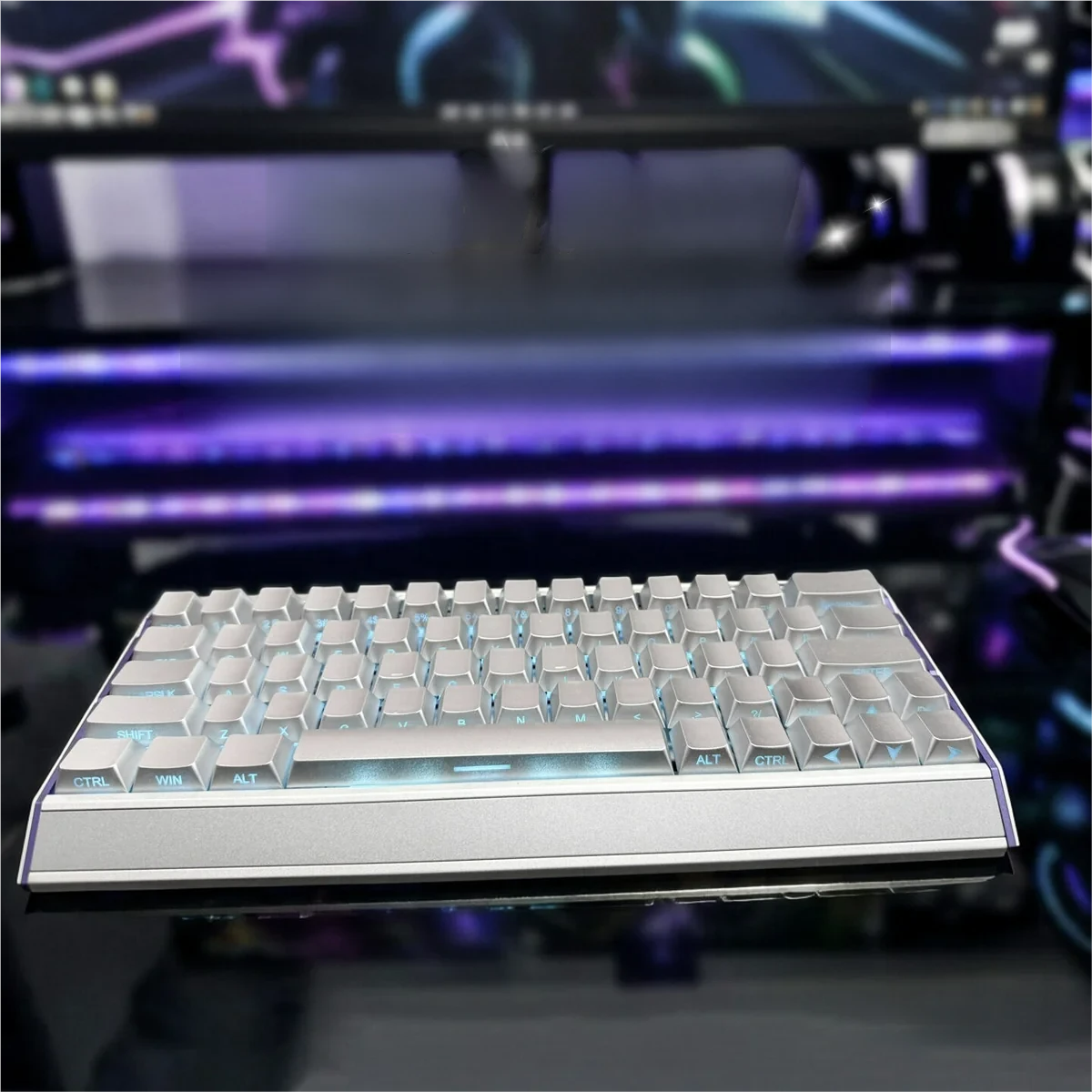 Close-up of a Luminous Silver keycap showing the intricate sculpted legend and reflective metallic surface.