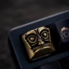 Artisan Sanxingdui keycap showcasing its lustrous copper finish