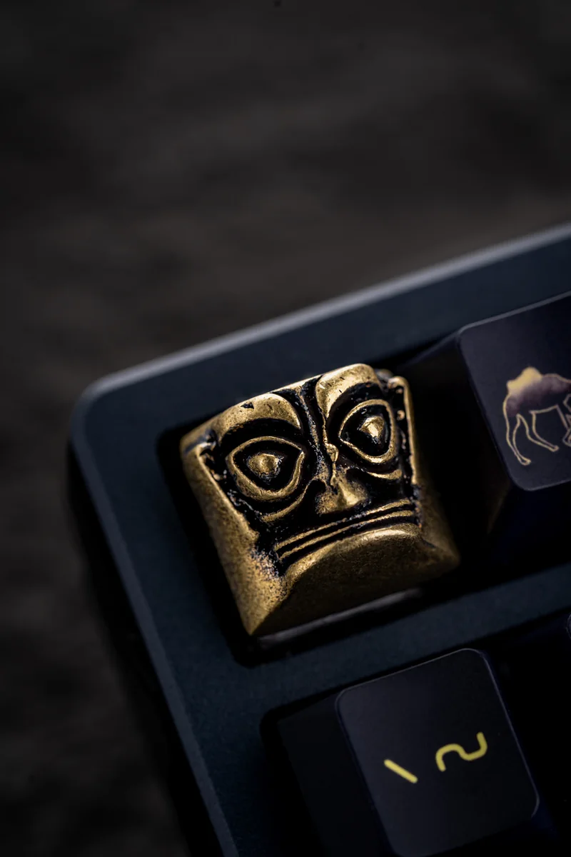Artisan Sanxingdui keycap showcasing its lustrous copper finish