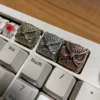 Close-up of Mystical Owl Copper Keycap, showcasing intricate details and metallic sheen.