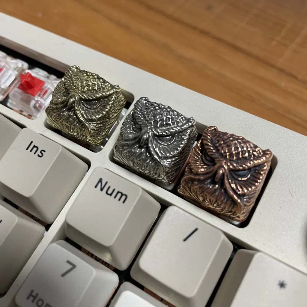 Close-up of Mystical Owl Copper Keycap, showcasing intricate details and metallic sheen.