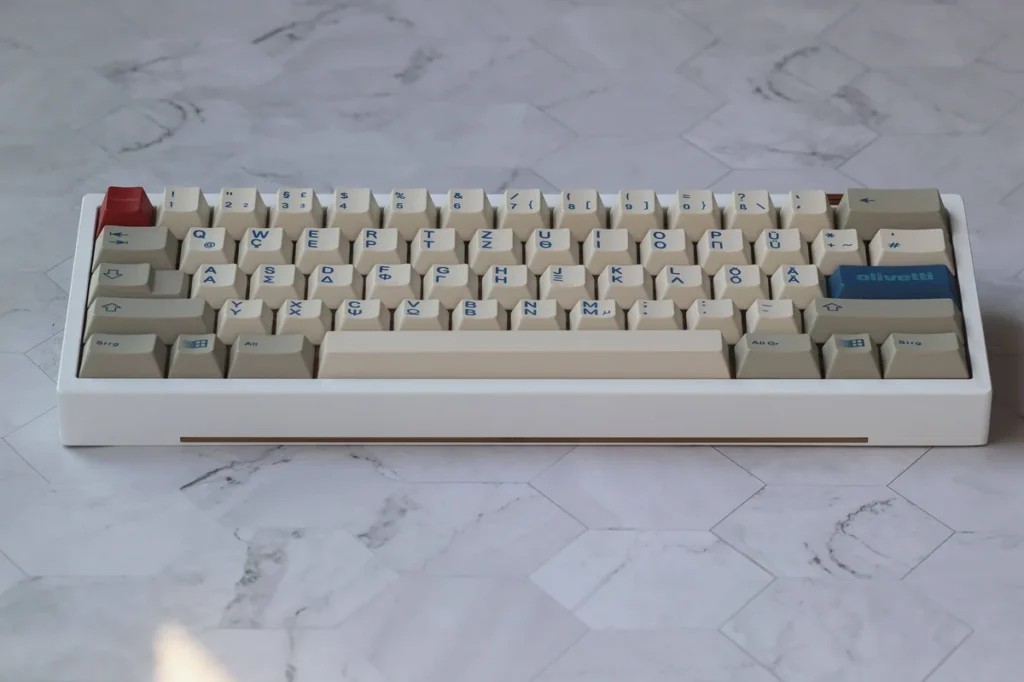 Olivetti PBT Keycap Set on a mechanical keyboard, showcasing vintage gray and white keycaps with Cherry profile.