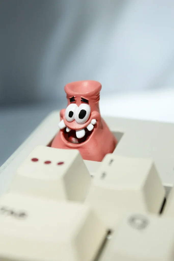 Handcrafted resin Patrick Star Head-Bonked artisan keycap on a mechanical keyboard