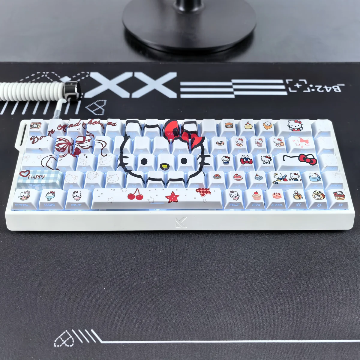 Detail shot of a Hello Kitty PBT keycap, emphasizing the texture and quality of the material.
