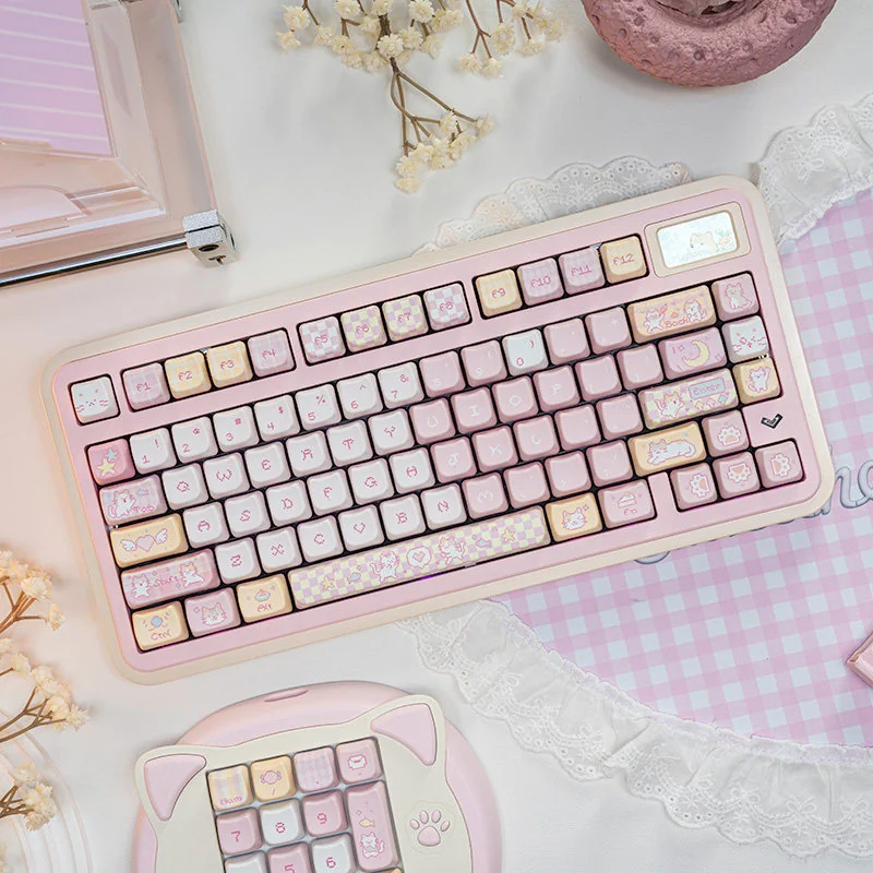 Pixel Cat Keycap Set installed on a pink or pastel-colored keyboard, demonstrating aesthetic pairing.