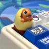 Close-up of a Pokemon hatching resin keycap, highlighting the detailed craftsmanship and smooth finish.