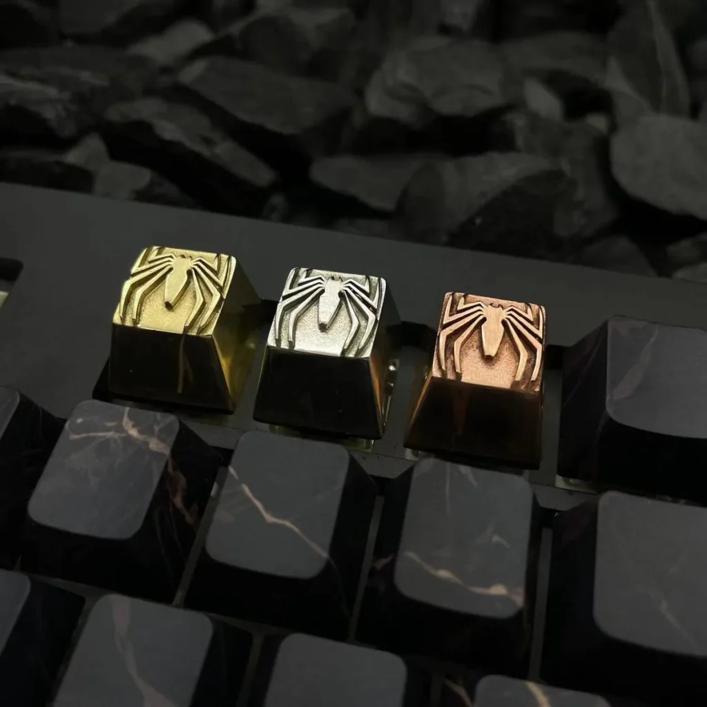 Close-up of Spider-Man logo copper keycap with vintage patina