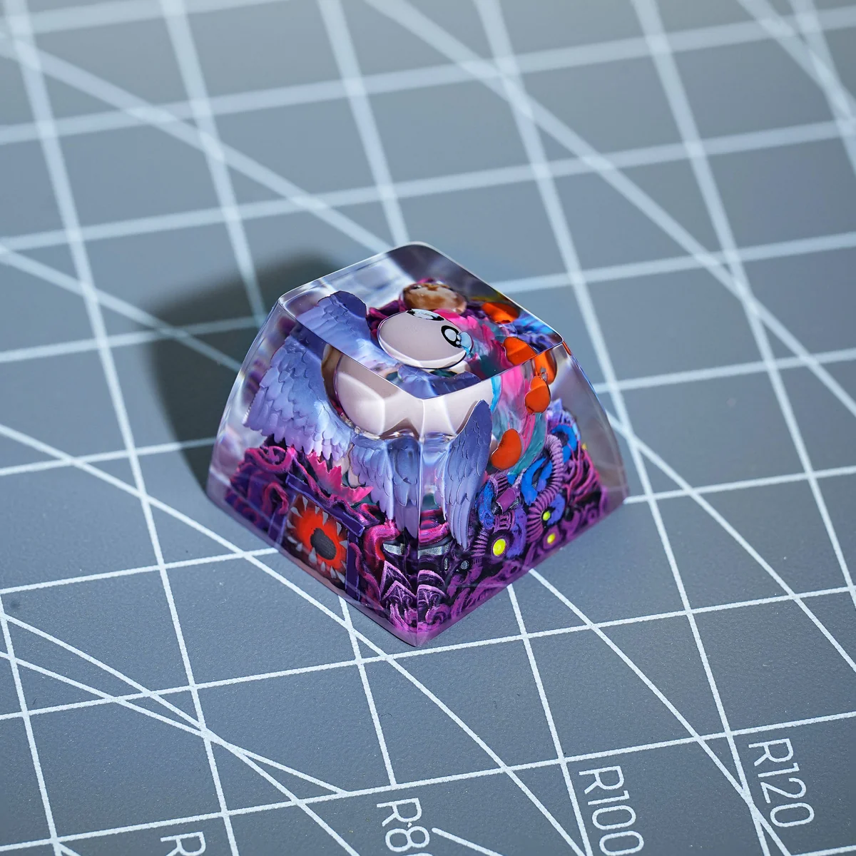 Side profile view of The Binding of Isaac keycap, demonstrating the tall, sculpted SA R1 profile and resin material.
