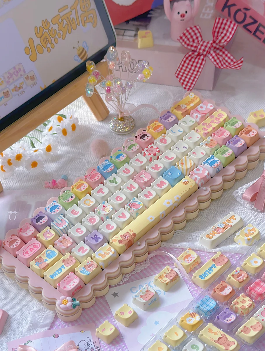 Whimsical Bear Doll keycaps installed on a keyboard, with a focus on the playful aesthetic and desk setup.