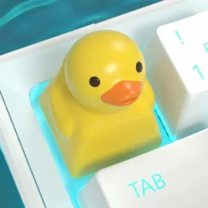 Handcrafted yellow duck resin keycap on a mechanical keyboard, top-down view.