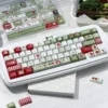 Green and red apple keycap set on a white mechanical keyboard