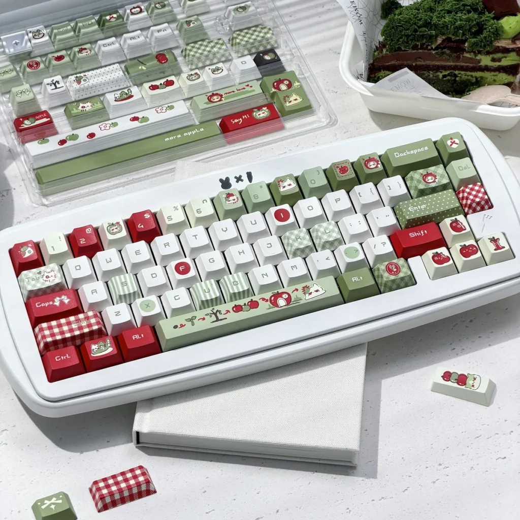 Green and red apple keycap set on a white mechanical keyboard