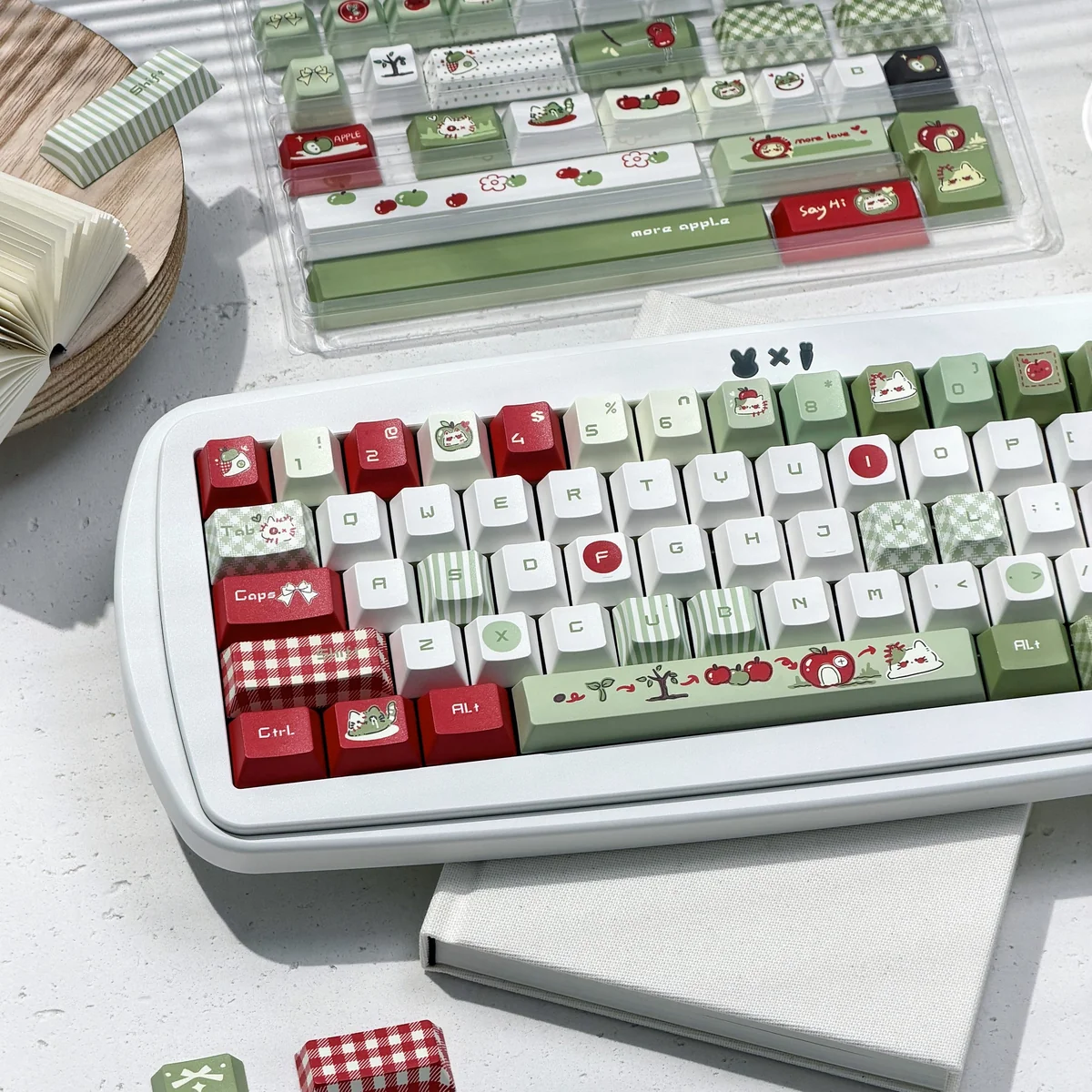 Close-up of apple motif PBT keycaps in Cherry profile