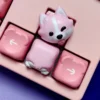 Adorable Corgi Butt Artisan Keycap in pink resin on a mechanical keyboard.