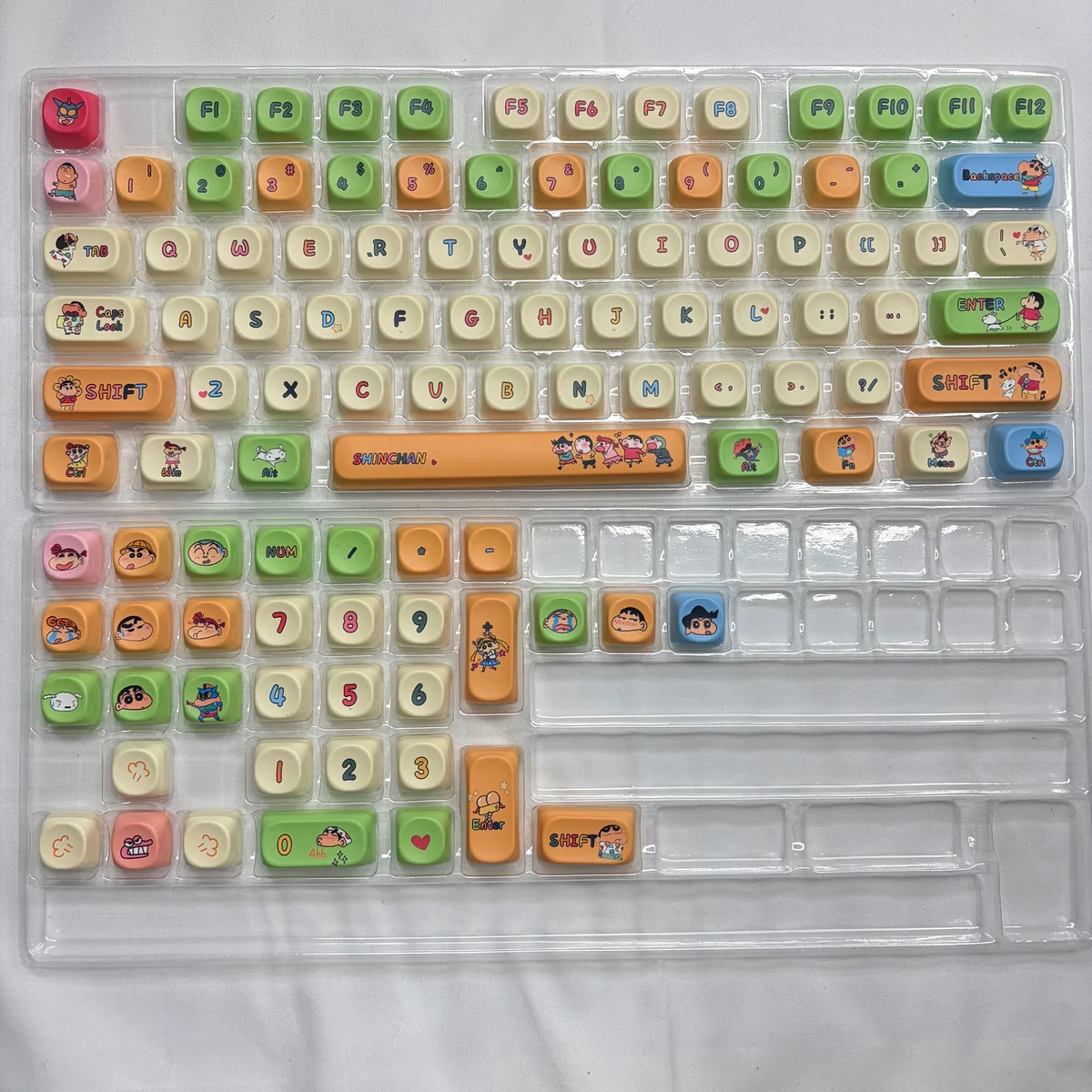 Lifestyle shot of the Crayon Shin-chan keycap set enhancing a desk setup with playful charm.