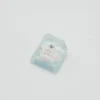 Maltese Dog artisan keycap styled on a desk with keyboard
