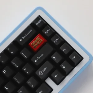 Close-up of the Game Over zinc alloy keycap, showcasing its metallic red and gold finish with clear 'Game Over' lettering on a mechanical keyboard.