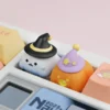 Ghost and pumpkin resin artisan keycaps shown side by side