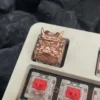 Hand holding the Oni Warrior keycap, demonstrating scale and craftsmanship.