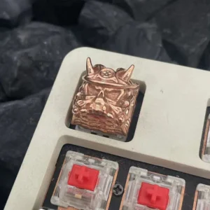 Hand holding the Oni Warrior keycap, demonstrating scale and craftsmanship.