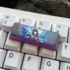 Detailed shot of the engraved Raiden Shogun design on the titanium keycap, emphasizing craftsmanship