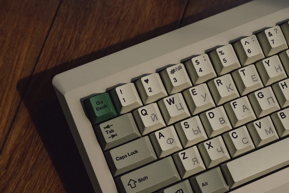 Close-up of hollow Russian legends on PBT keycaps, vintage grey-white color